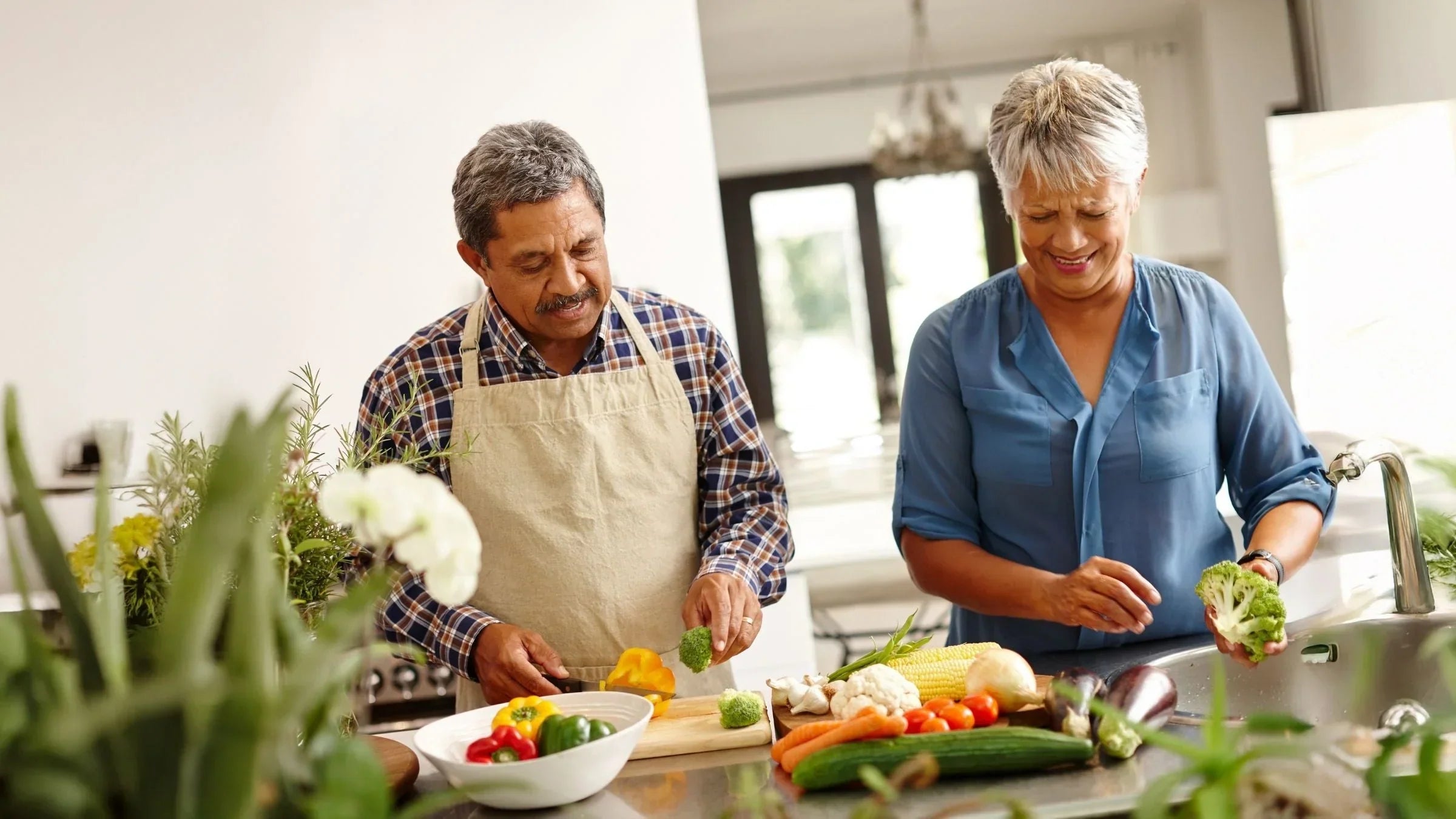 An older couple preparing a meal together in their kitchen for MaxiMeal Blog