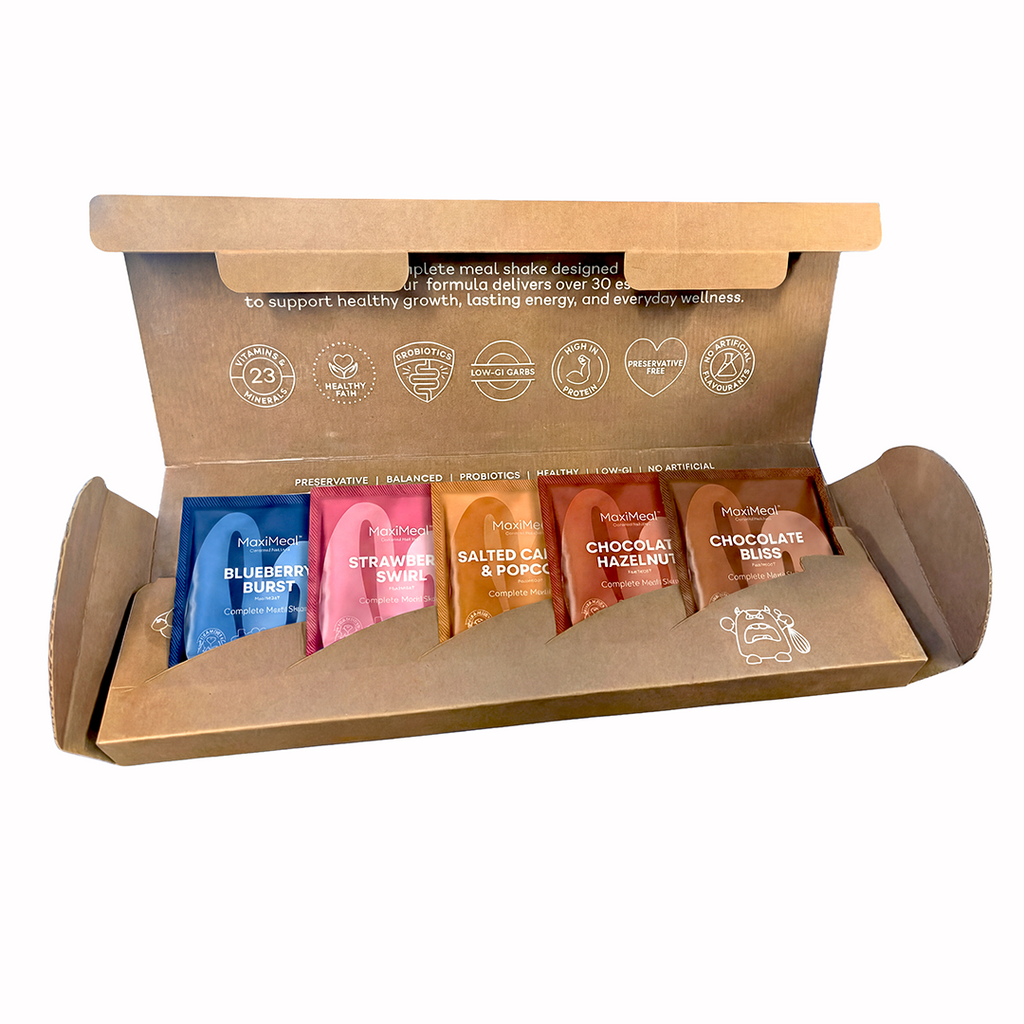 MaxiMeal complete meal shake trial box open to reveal five flavour sachets including Blueberry Burst, Strawberry Swirl, Salted Caramel Popcorn, Chocolate Hazelnut, and Chocolate Bliss, with 23 vitamins and minerals, probiotics, low GI, and no artificial ingredients.