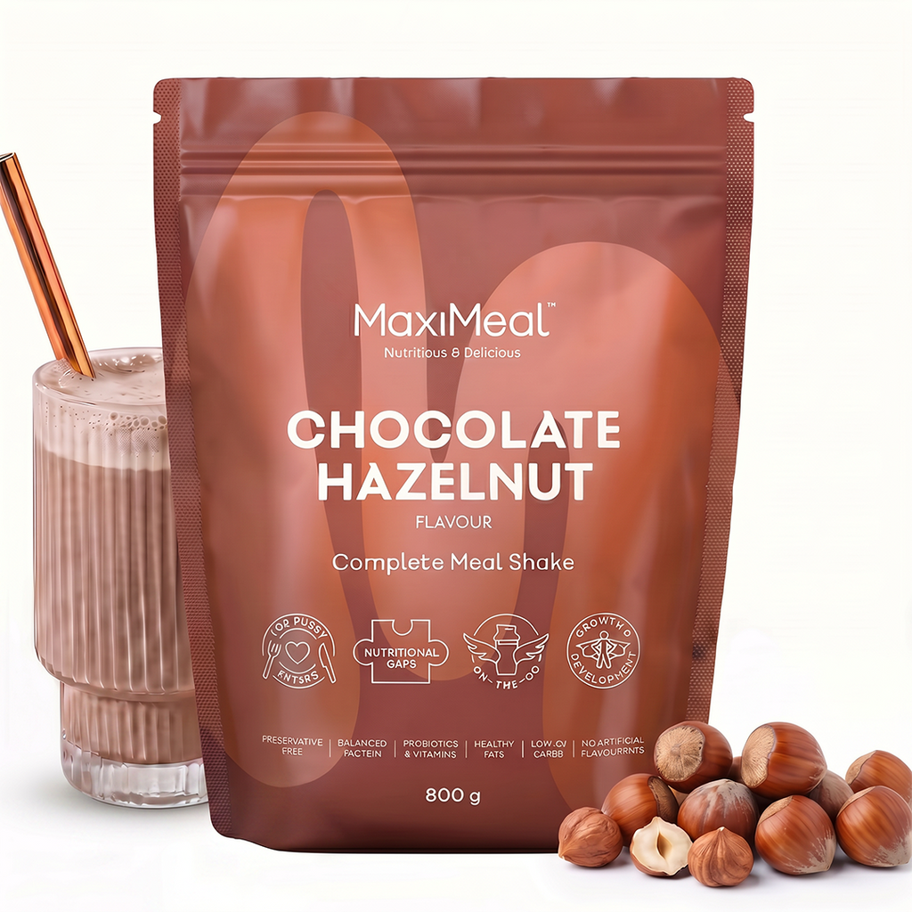 MaxiMeal Chocolate Hazelnut complete meal shake 800g pouch styled with a chocolate shake in a ribbed glass and whole hazelnuts, showing the flavour profile and…MaxiMeal Chocolate Hazelnut complete meal shake 800g pouch styled with a chocolate shake in a ribbed glass and whole hazelnuts, showing the flavour profile and ready-to-drink result, non-GMO, maltodextrin free, no artificial sweeteners, preservative free with balanced protein, probiotics, vitamins, health
